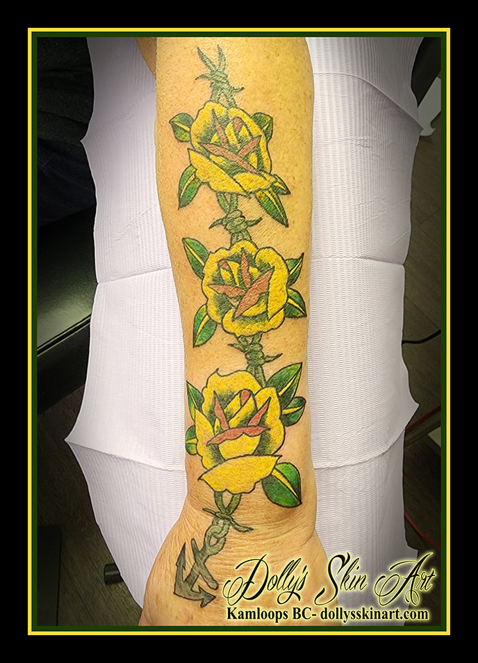roses tattoo traditional colour yellow barbed wire andchor red green leaves forearm black grey tattoo dolly's skin art kamloops