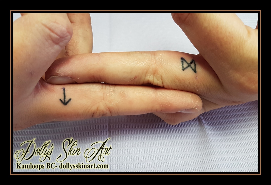 black single line rune symbol side finger tattoo kamloops dolly's skin art